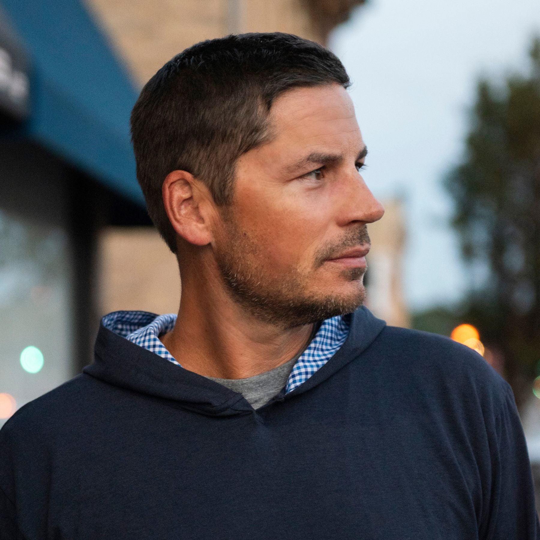 Man wearing a navy Nantucket Deckhand Hoodie outdoors